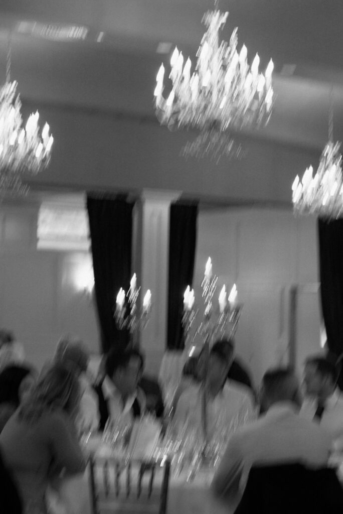 a blurry photo of guests at a wedding reception in a castle
