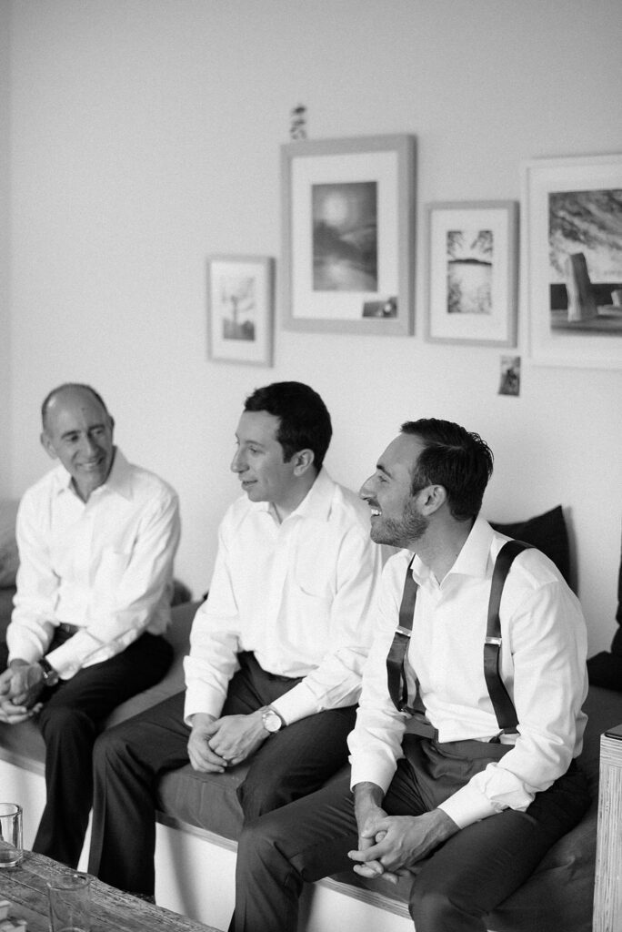 Black and white photograph of groom and groomsmen laughing before wedding at Mass MoCA