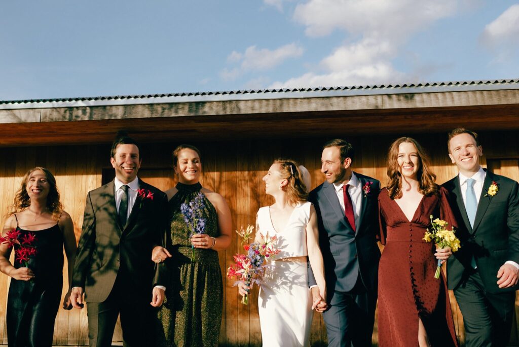 Massachusetts wedding party smiles and walks together