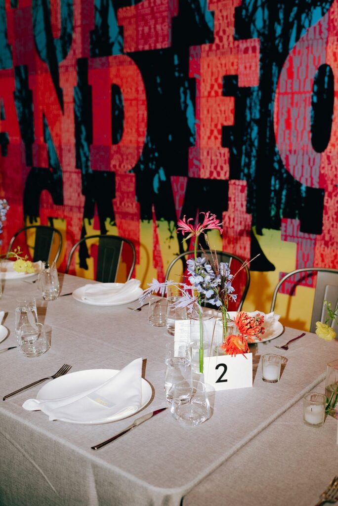 Dramatic art serves as a backdrop to wedding place settings at Mass MoCA