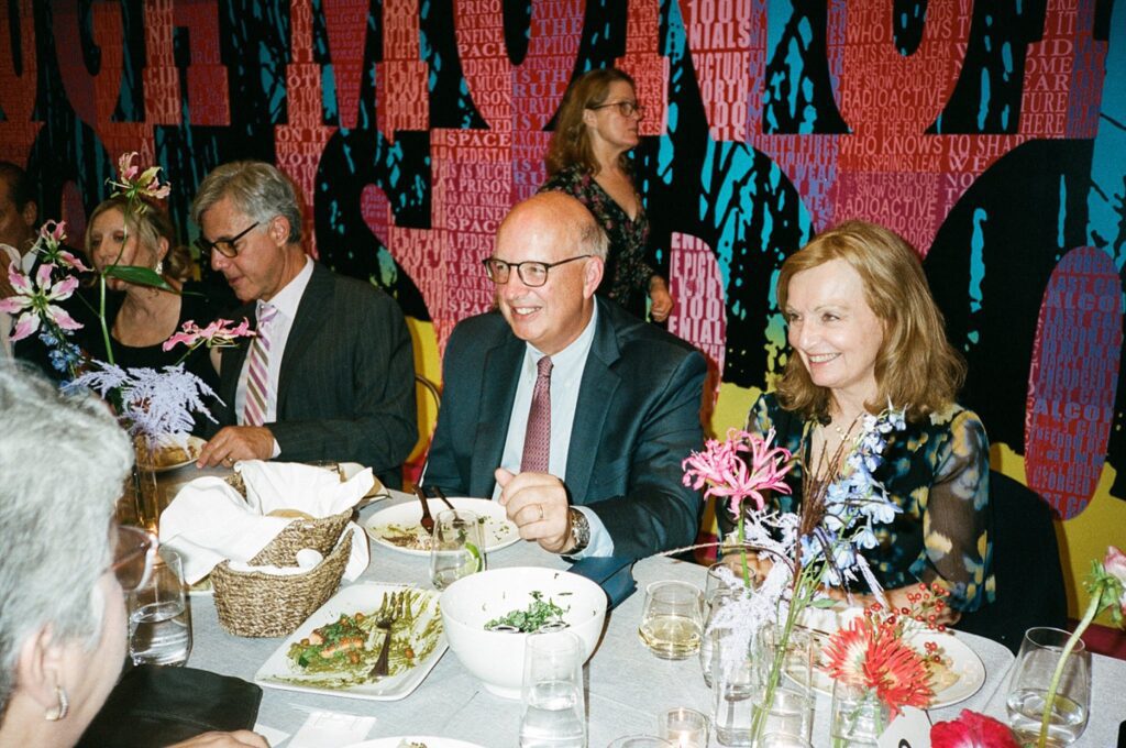 Guests smile while enjoying dinner at Massachusetts wedding