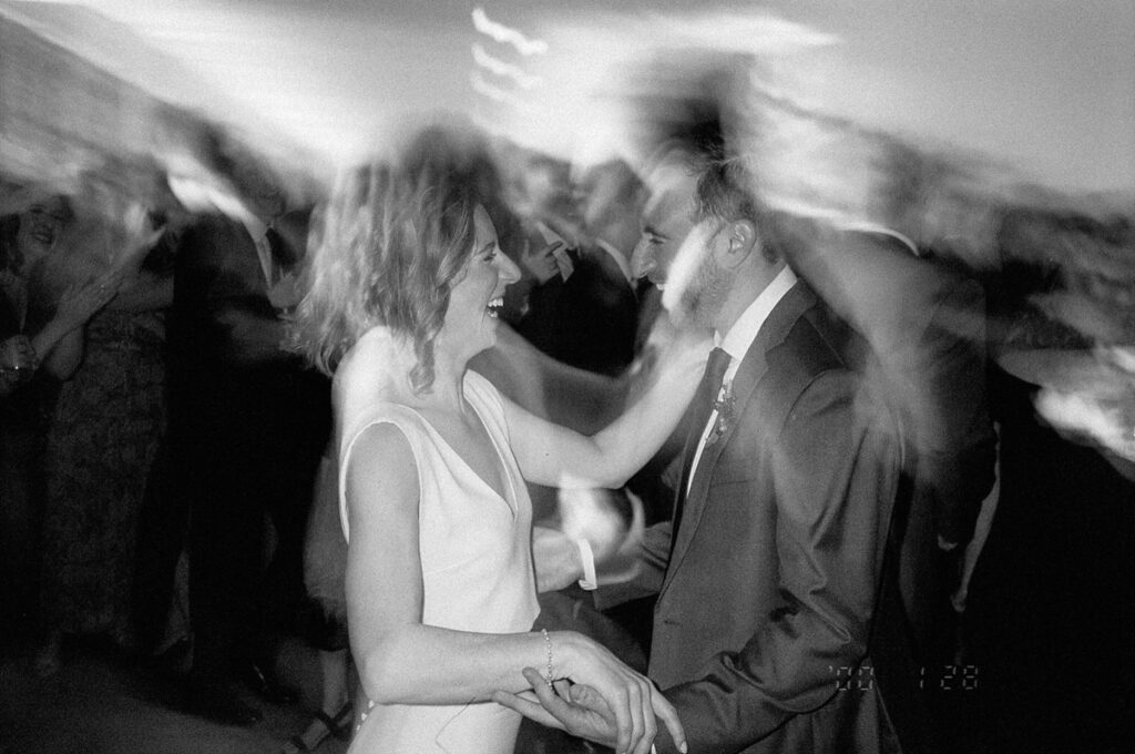 Motion blur surrounds bride and groom while they dance at their wedding