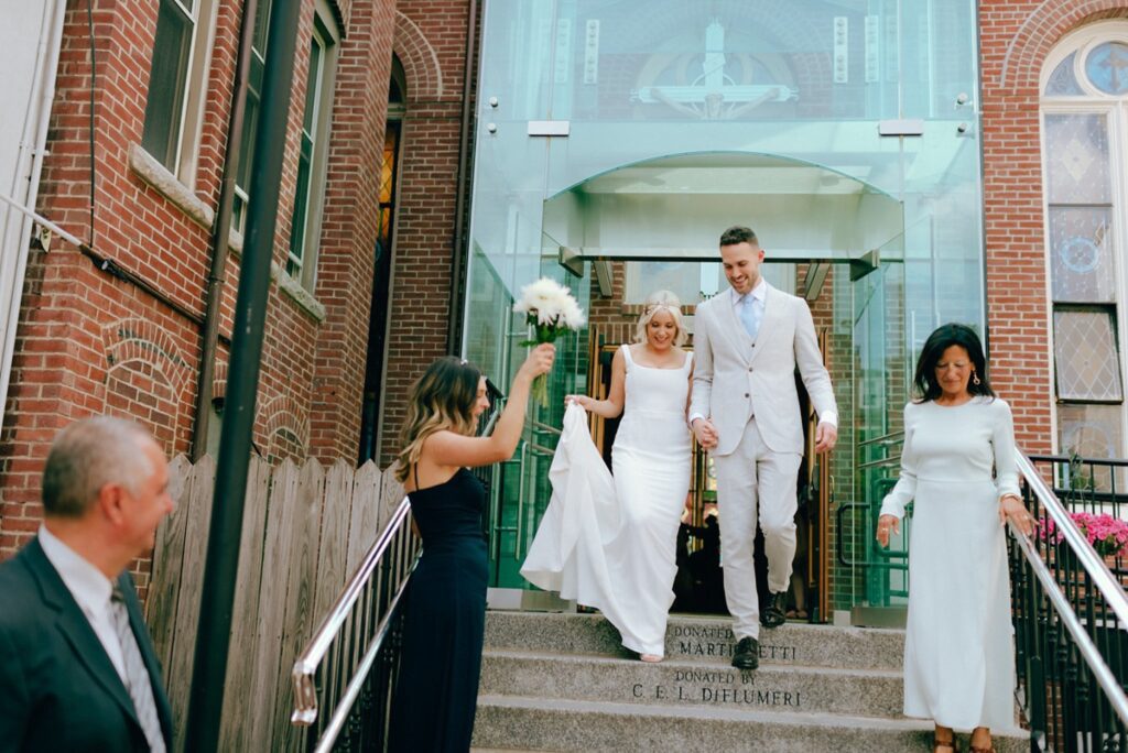 a couple exits a church after their wedding ceremony