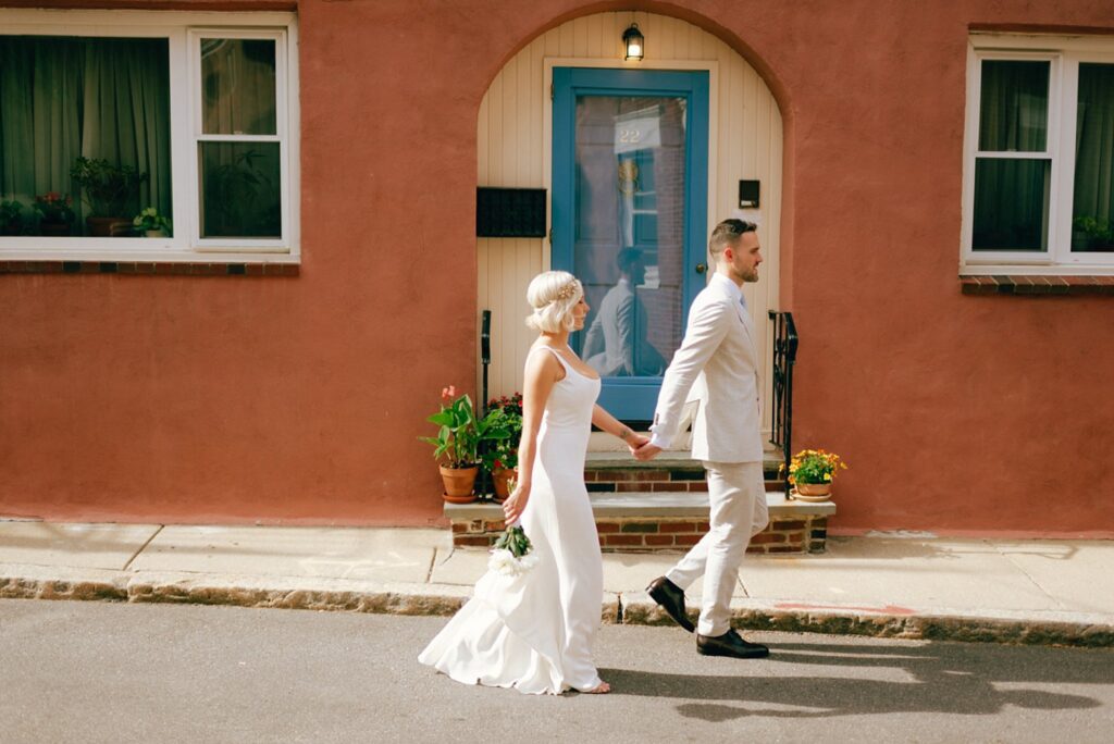 A couple strolls in Boston's North End for their wedding portraits