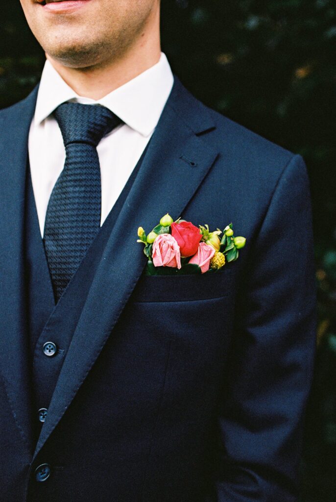 Detailed film photograph of the groom's boutonniere.