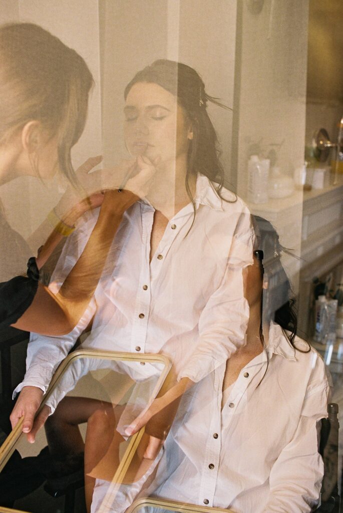 Creative double exposure film image of the bride during her makeup preparation, highlighting Ramblefree Photo Co.'s artistic eye and unique film techniques.
