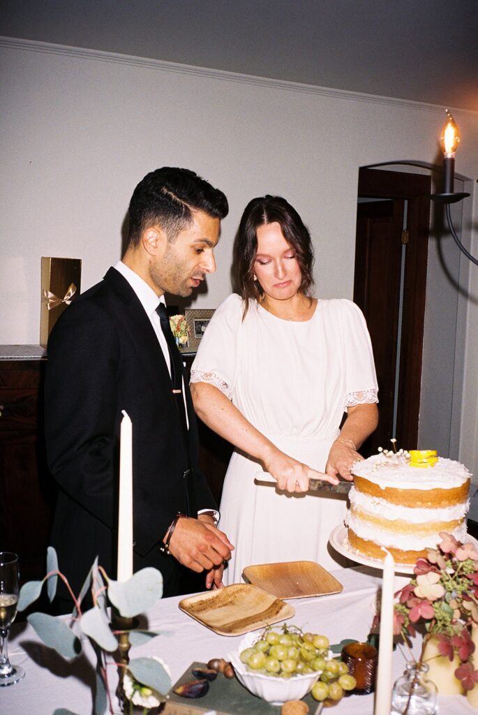 a bride and groom cutting their cake