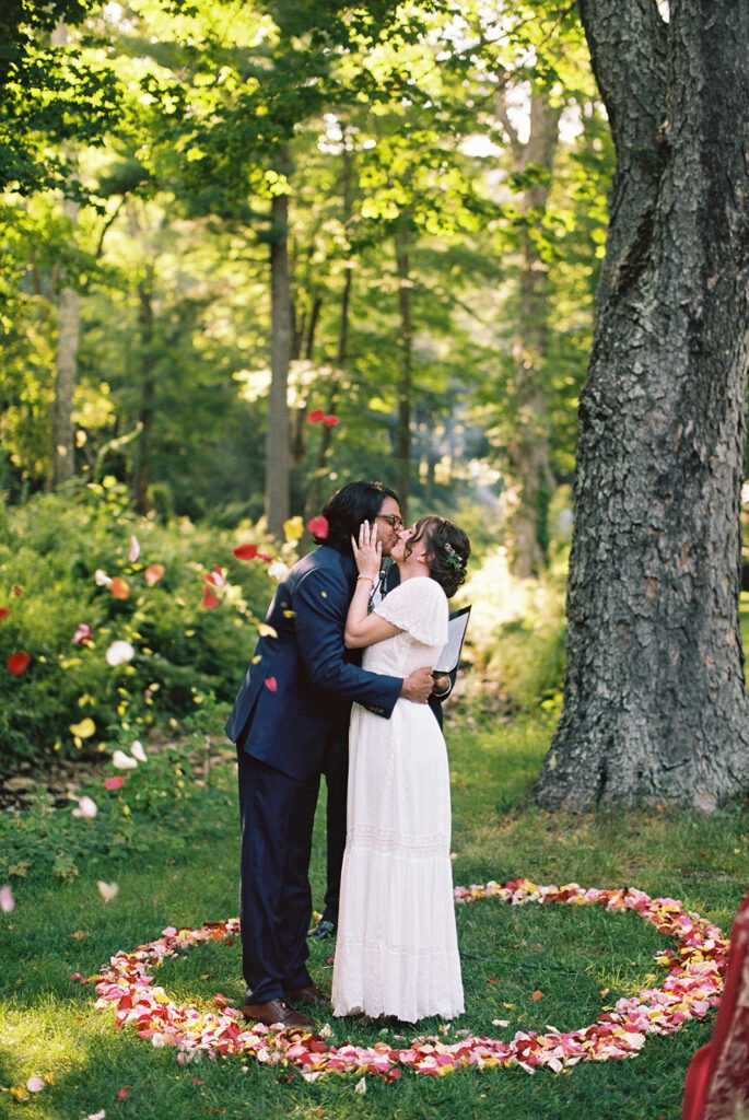 a couple kisses at their Race Brook Lodge wedding ceremony in the Berkshires