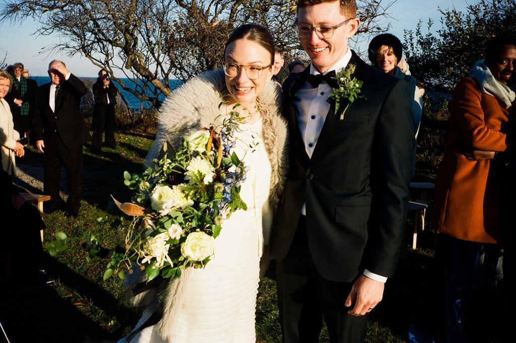 a bride and groom smile after their wedding ceremony