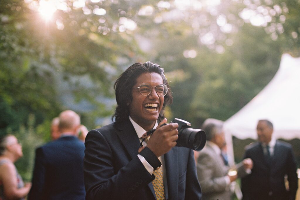 a guest at a cocktail hour laughs