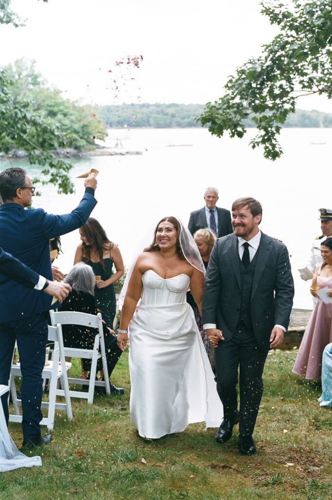 a bride and groom walk up the aisle after a wedding ceremony
