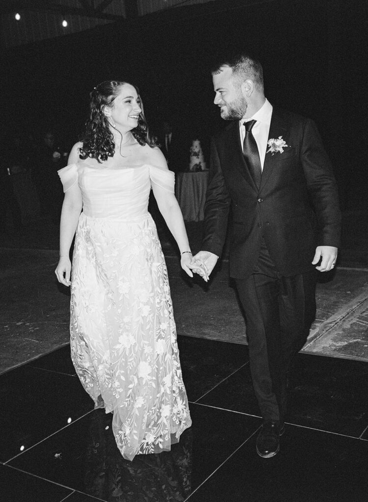 a bride and groom enter their reception