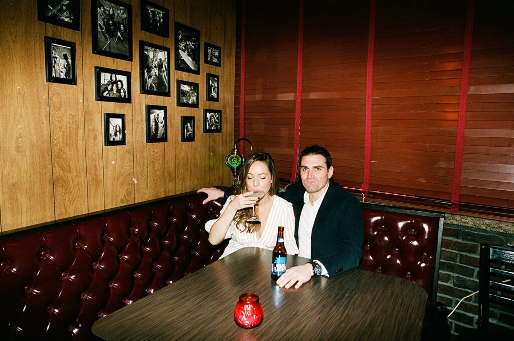 a couple enjoys drinks at their favorite bar