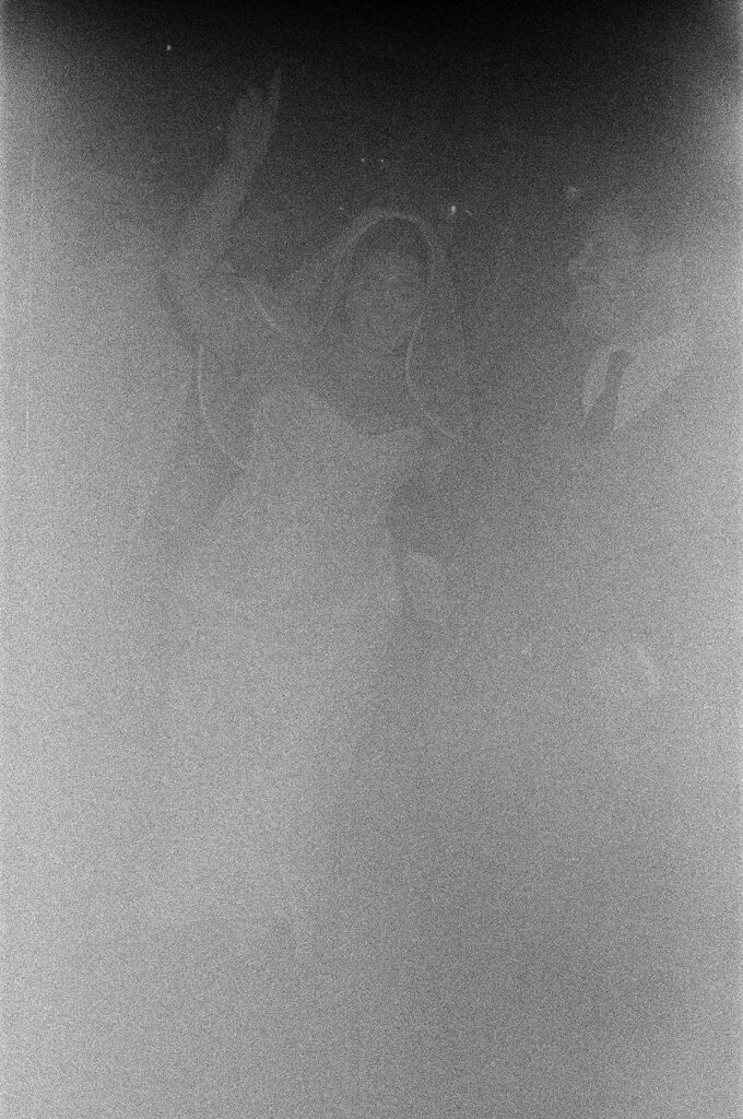 a grainy film photo of a bride and a groom