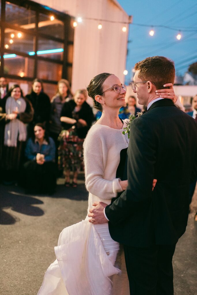 Documentary style wedding film photograph of bride and groom dancing