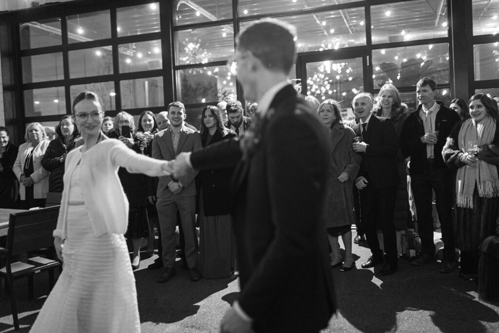 Black and white film photograph of couple dancing at their restaurant wedding, shot by Perth wedding photographer