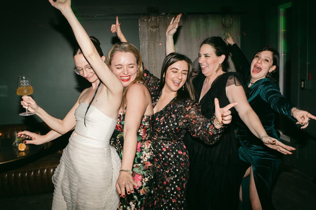 Bride and guests dance, candid photo on film of them at the reception