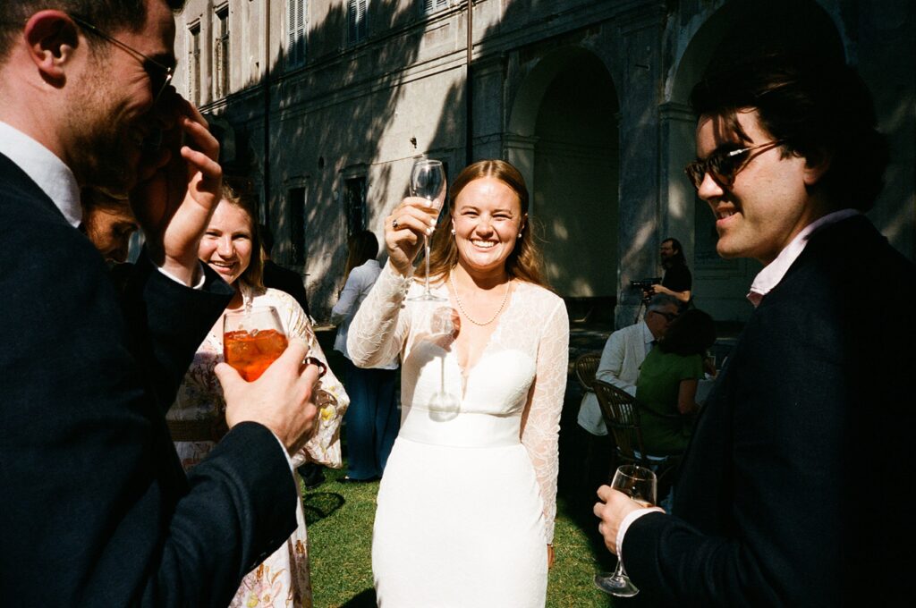 a bride holds up her glass in a toast