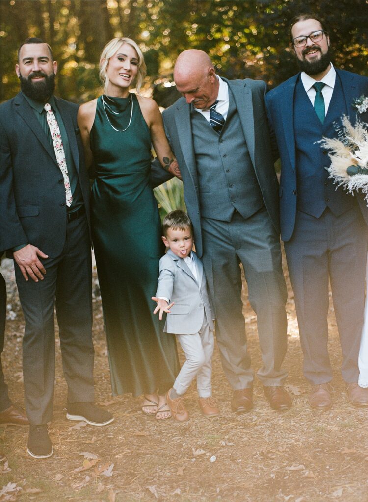 a family posing for a portrait on a wedding da