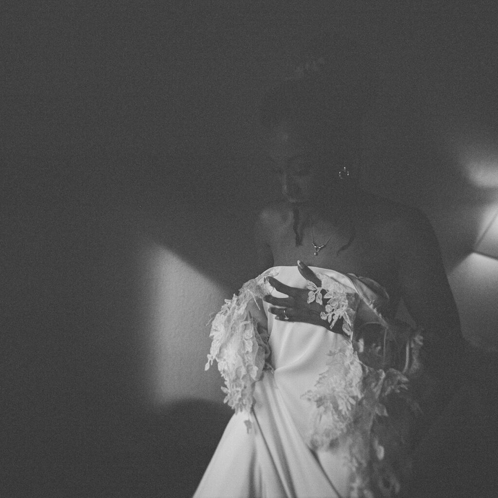 a bride putting on her Danielle Frankel studios wedding dress