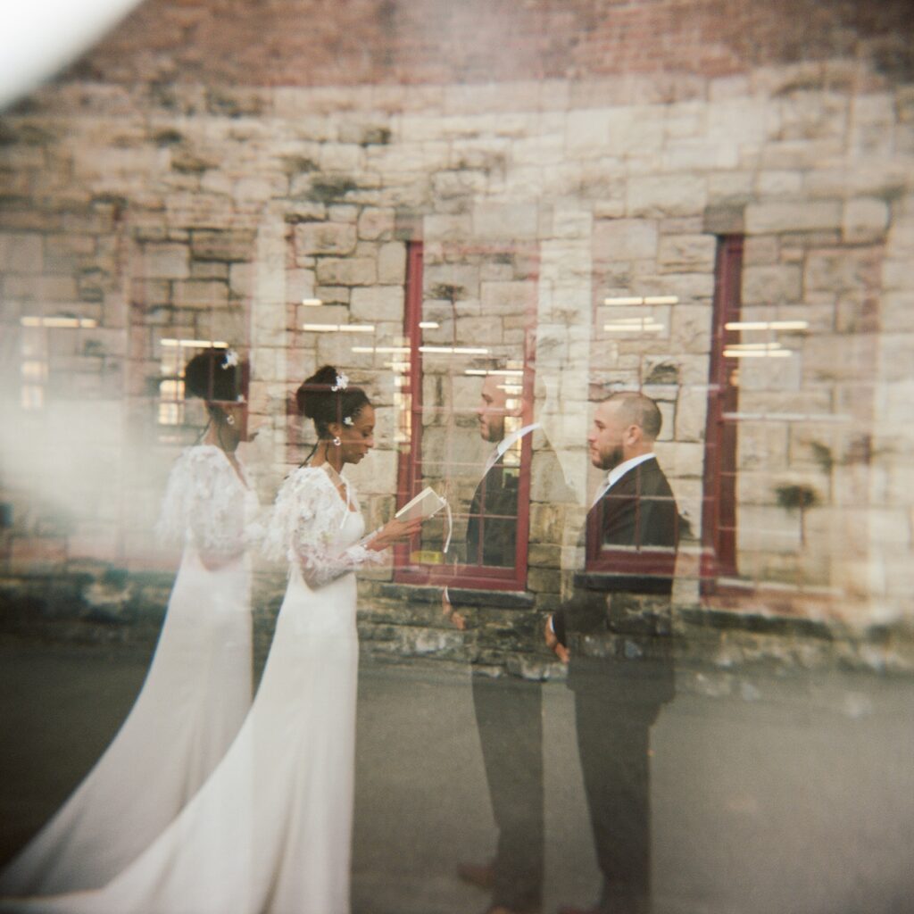 a bride and a groom read private vows to each other