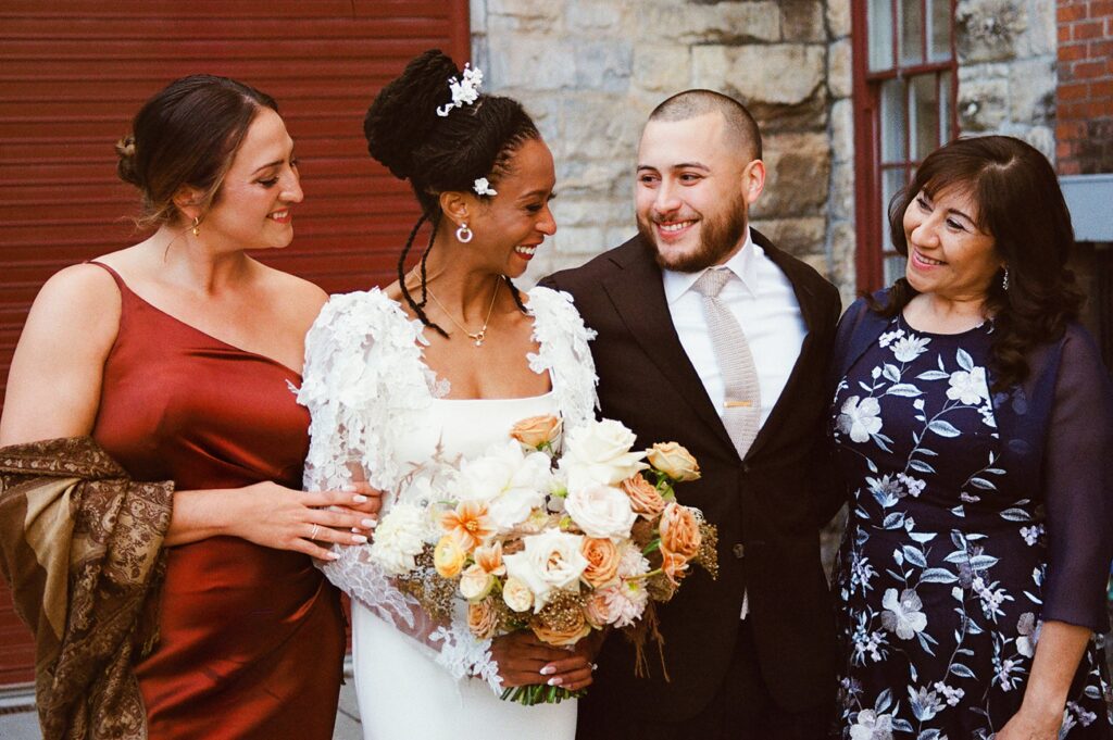 a couple poses for family photos at their wedding