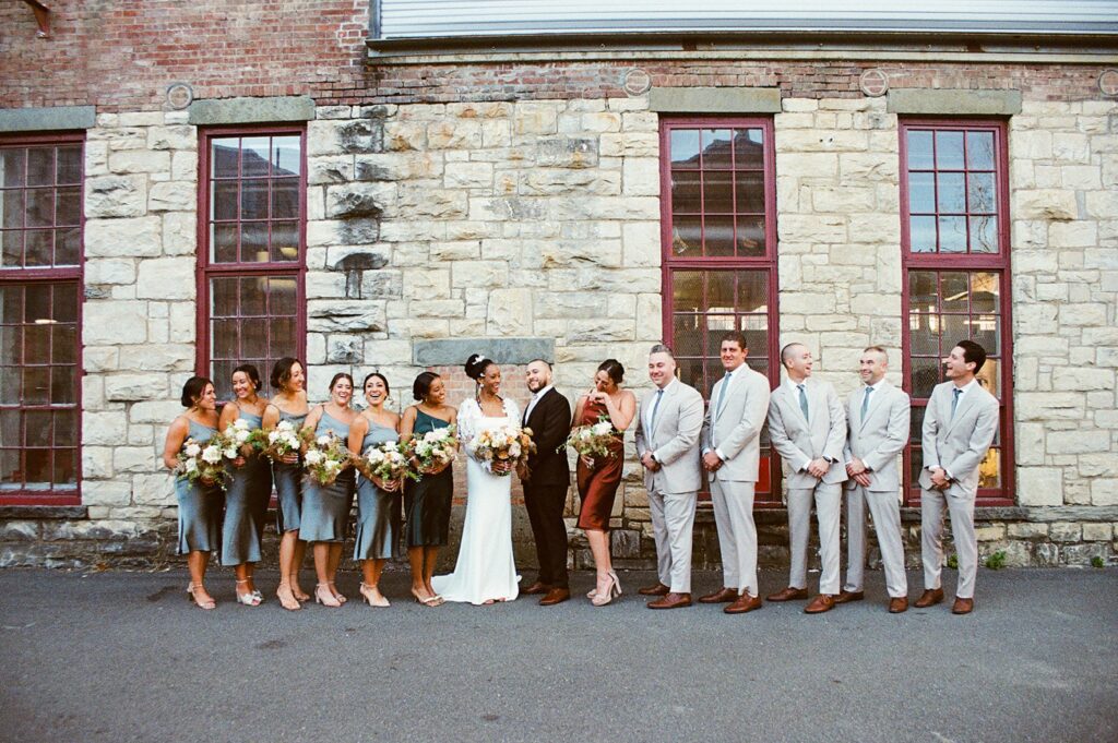 a couple poses for a wedding party photo