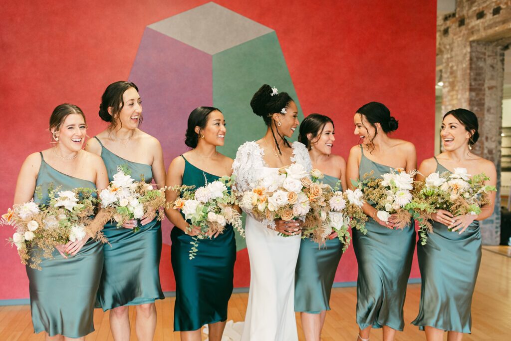 a wedding party gathers around a bride at a museum wedding