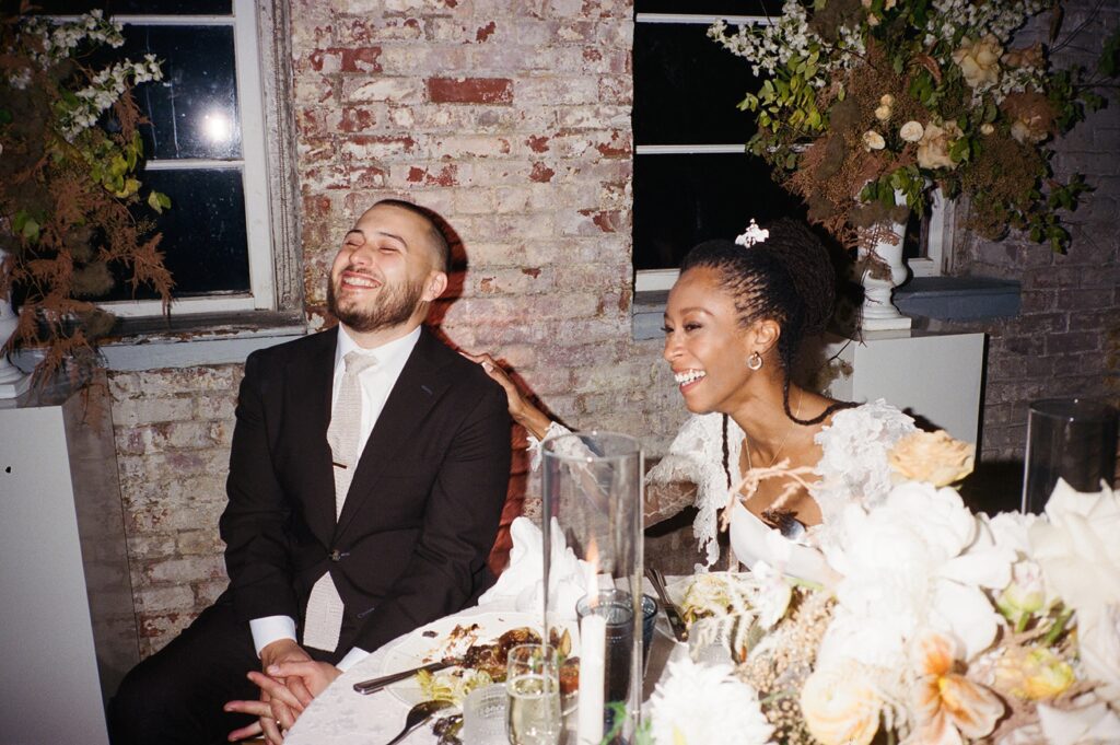 a couple laughs during their wedding toasts