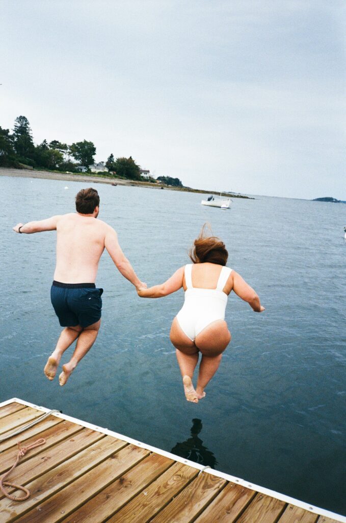 a bride and a groom doing a cold plunge the morning of their wedding