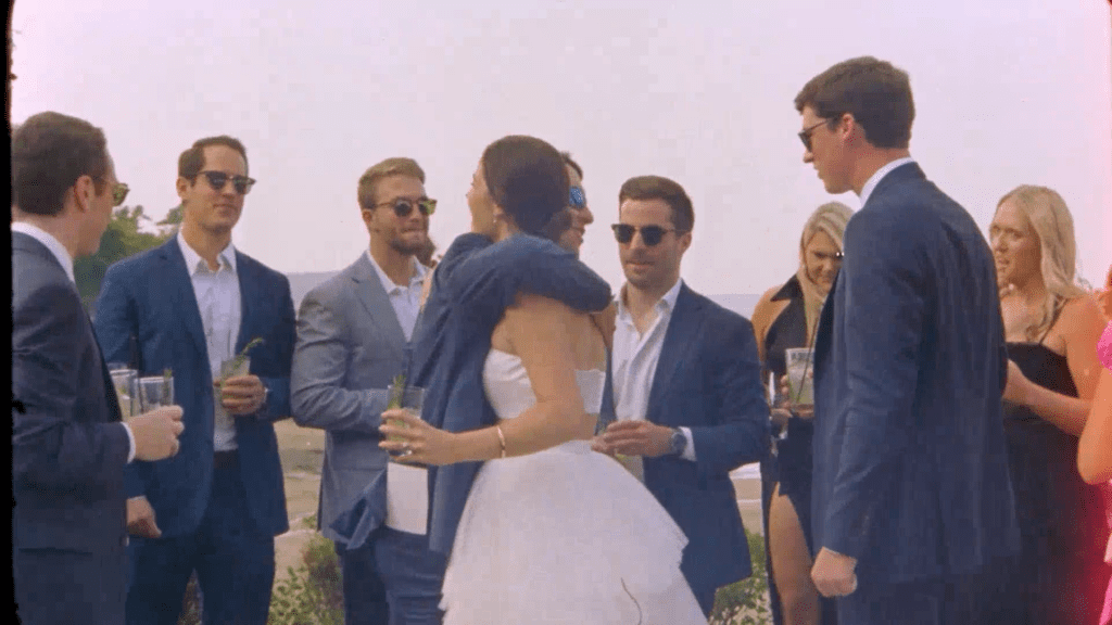 a wedding guest hugs a bride