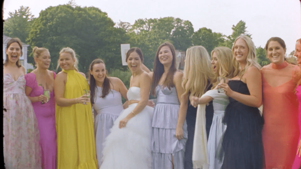 a bride poses with her friends at her wedding