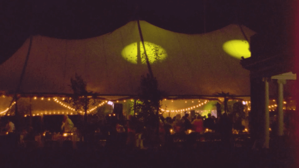 a reception tent lit up at night